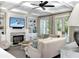 A stylish living room featuring built-in shelves, fireplace, and a ceiling fan at 2805 Stay Sail Way, Mount Pleasant, SC 29466