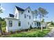 Stunning white home showcasing a side exterior with well-manicured landscaping at 2805 Stay Sail Way, Mount Pleasant, SC 29466