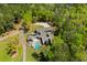 Stunning aerial view of a modern home with a private pool nestled amidst lush green trees at 2885 Plow Ground Rd, Johns Island, SC 29455