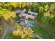 Aerial view of the modern home featuring a luxurious pool, surrounded by lush greenery and mature trees at 2885 Plow Ground Rd, Johns Island, SC 29455