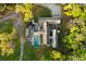 Scenic aerial view of modern home with unique architecture, private pool, access road and surrounding forest at 2885 Plow Ground Rd, Johns Island, SC 29455