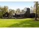 Expansive backyard with well-manicured lawn and sophisticated modern home with pool at 2885 Plow Ground Rd, Johns Island, SC 29455