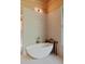 Modern bathroom featuring a stylish soaking tub, wood accents, and tiled walls and flooring at 2885 Plow Ground Rd, Johns Island, SC 29455