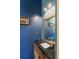 This powder room boasts a blue wall, a framed picture and a marble countertop with a stylish faucet at 2885 Plow Ground Rd, Johns Island, SC 29455
