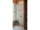 Modern bathroom featuring tiled walls, a rainfall shower head, and rustic wood shelving and detailing at 2885 Plow Ground Rd, Johns Island, SC 29455