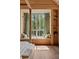 Bedroom featuring a window seat with scenic nature views, wood paneled walls, and built-in shelving at 2885 Plow Ground Rd, Johns Island, SC 29455