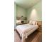 A tranquil bedroom features a light pink quilt, minimalist decor, and a built-in desk for a serene living experience at 2885 Plow Ground Rd, Johns Island, SC 29455