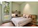 This cozy bedroom has a view to the trees and light green walls at 2885 Plow Ground Rd, Johns Island, SC 29455