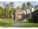 Charming home featuring modern design, wood siding, large windows, and a inviting stone pathway at 2885 Plow Ground Rd, Johns Island, SC 29455