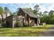 Modern home featuring dark wooden siding, metal roof, and inviting outdoor storage space at 2885 Plow Ground Rd, Johns Island, SC 29455