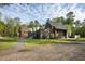 Beautiful contemporary home with wood siding, striking architectural details and gravel drive at 2885 Plow Ground Rd, Johns Island, SC 29455