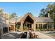 Modern home showcasing clean lines, large windows, and inviting outdoor seating at 2885 Plow Ground Rd, Johns Island, SC 29455