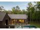 Modern home featuring a spacious pool area, floor-to-ceiling windows, and a well-manicured lawn at 2885 Plow Ground Rd, Johns Island, SC 29455