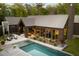 Aerial view of a modern home with a sleek pool, complemented by stylish outdoor furniture and ample natural light at 2885 Plow Ground Rd, Johns Island, SC 29455