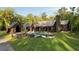 Stunning exterior view of a modern home with a pool and lush green lawn surrounded by mature trees at 2885 Plow Ground Rd, Johns Island, SC 29455