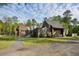 Beautiful contemporary home with wood siding, striking architectural details and gravel drive at 2885 Plow Ground Rd, Johns Island, SC 29455