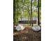 House nestled among trees with two kayaks out front; the exterior complements the natural wooded setting at 2885 Plow Ground Rd, Johns Island, SC 29455