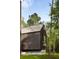 Modern home with metal roof and dark siding, nestled in lush greenery at 2885 Plow Ground Rd, Johns Island, SC 29455
