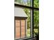 View from inside looking out at exterior shed with wood siding, metal roof, and lush green trees at 2885 Plow Ground Rd, Johns Island, SC 29455