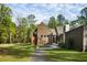 Charming home featuring modern design, wood siding, large windows, and a inviting stone pathway at 2885 Plow Ground Rd, Johns Island, SC 29455