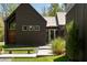 Modern home with wood siding, ample natural light from large windows, and lush green landscaping at 2885 Plow Ground Rd, Johns Island, SC 29455