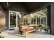 Charming exterior patio featuring a dining table, benches, and seamless access through sliding glass doors at 2885 Plow Ground Rd, Johns Island, SC 29455