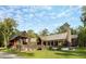 Stunning modern home featuring a metal roof, a wall of windows, and meticulously landscaped surroundings at 2885 Plow Ground Rd, Johns Island, SC 29455