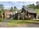 Stunning contemporary home with wood siding, well-manicured lawn, and unique architectural design at 2885 Plow Ground Rd, Johns Island, SC 29455