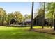 Exterior view of a modern home surrounded by lush greenery, featuring a dark exterior and natural light at 2885 Plow Ground Rd, Johns Island, SC 29455