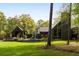 Breathtaking backyard of this stylish home, complete with mature trees and modern pool area at 2885 Plow Ground Rd, Johns Island, SC 29455