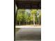 Exterior view from inside the garage, showcasing the outdoor area and wooded landscape at 2885 Plow Ground Rd, Johns Island, SC 29455