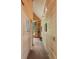 Long, light hallway featuring wood-paneled walls and artwork at 2885 Plow Ground Rd, Johns Island, SC 29455