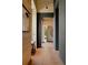 Modern hallway with light wood paneling, black accent trim, and hardwood flooring at 2885 Plow Ground Rd, Johns Island, SC 29455