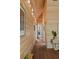 Hallway featuring wood walls, wood floors, light fixtures, and artwork at 2885 Plow Ground Rd, Johns Island, SC 29455
