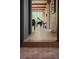 Bright hallway with floor to ceiling windows and a view of the grand piano and lush greenery at 2885 Plow Ground Rd, Johns Island, SC 29455