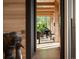 Inviting hallway with wood-paneled walls, wood beams, and a piano room at the end at 2885 Plow Ground Rd, Johns Island, SC 29455