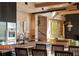 Open kitchen design with wood accents, stainless appliances, and island seating with backyard views at 2885 Plow Ground Rd, Johns Island, SC 29455
