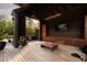 Stylish outdoor living space with wood finishes and a TV, perfect for relaxation and entertaining at 2885 Plow Ground Rd, Johns Island, SC 29455