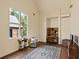 Sun-lit living room with a large window, desk, chair, and a patterned rug on hardwood floors at 2885 Plow Ground Rd, Johns Island, SC 29455