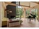 Bright living room featuring floor-to-ceiling windows, a fireplace, and elegant hardwood floors at 2885 Plow Ground Rd, Johns Island, SC 29455