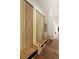A stylish mudroom boasts custom built-in benches, wood paneled walls, and hardwood floors at 2885 Plow Ground Rd, Johns Island, SC 29455