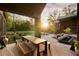 Captivating outdoor dining area with warm sunlight filtering through trees, overlooking the pool and backyard at 2885 Plow Ground Rd, Johns Island, SC 29455