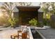 Relaxing outdoor lounge area featuring stylish seating and lush greenery with a flat-screen television at 2885 Plow Ground Rd, Johns Island, SC 29455