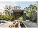 Inviting outdoor living space with comfortable seating, lush plants, and a custom shed-roof structure at 2885 Plow Ground Rd, Johns Island, SC 29455