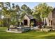 Inviting pool area with modern pool house, lush greenery, and a serene outdoor ambiance, perfect for relaxation at 2885 Plow Ground Rd, Johns Island, SC 29455
