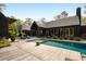 Back view of the house with its inviting pool, complete with lounge chairs and serene landscaping at 2885 Plow Ground Rd, Johns Island, SC 29455