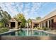 Backyard featuring a stunning in-ground pool, a wooden patio, and lush landscaping at 2885 Plow Ground Rd, Johns Island, SC 29455