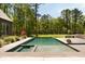 The sparkling pool merges with the lush green yard, blending recreation and nature into a seamless and refreshing experience at 2885 Plow Ground Rd, Johns Island, SC 29455