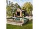 Beautiful pool and pool house surrounded by lush greenery for a tranquil outdoor living space at 2885 Plow Ground Rd, Johns Island, SC 29455