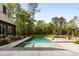 This expansive pool seamlessly merges with the lush green lawn, creating a refreshing and tranquil outdoor retreat at 2885 Plow Ground Rd, Johns Island, SC 29455